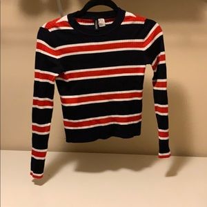 Cropped long sleeve red white and blue shirt.